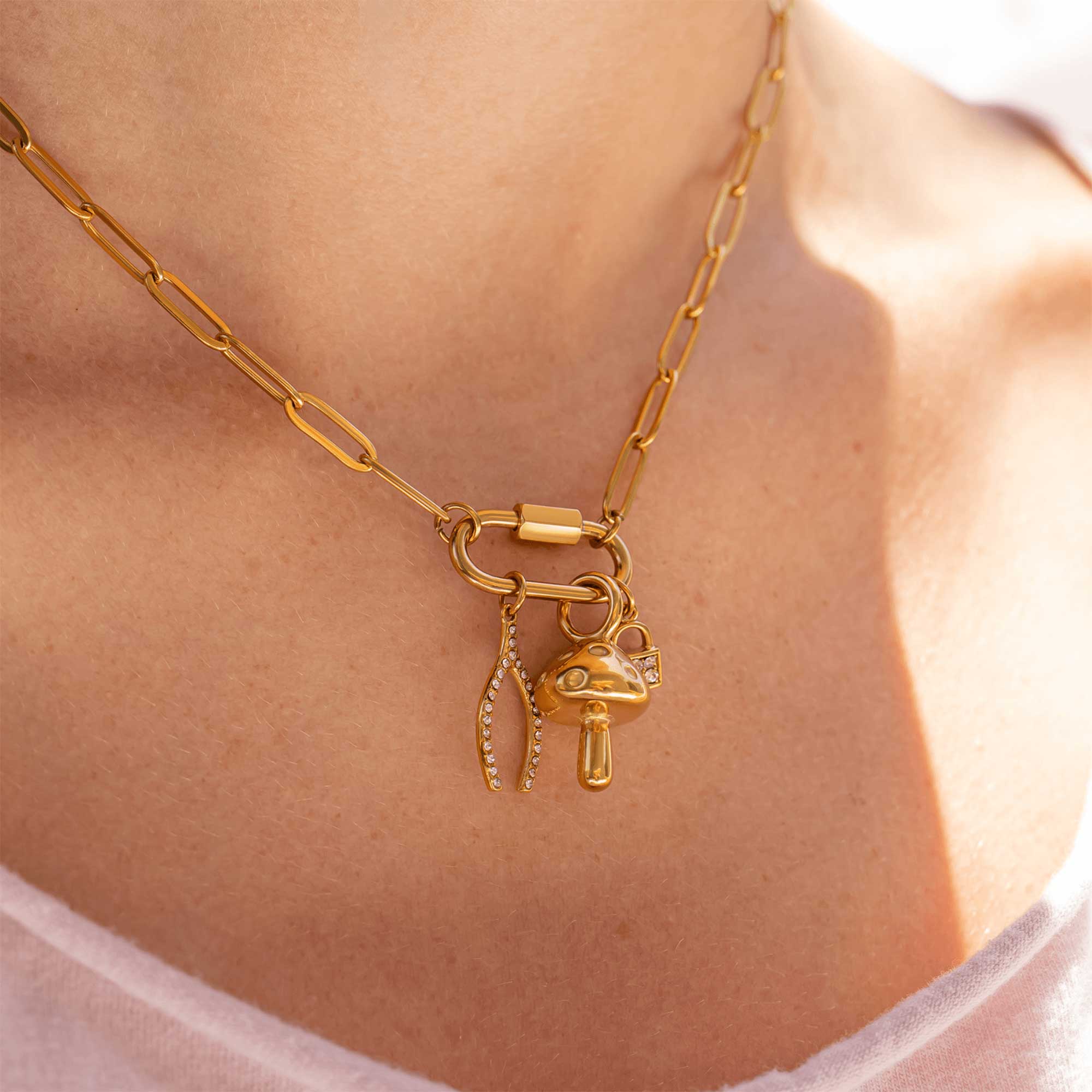 Gold necklace with charms on a person's neck