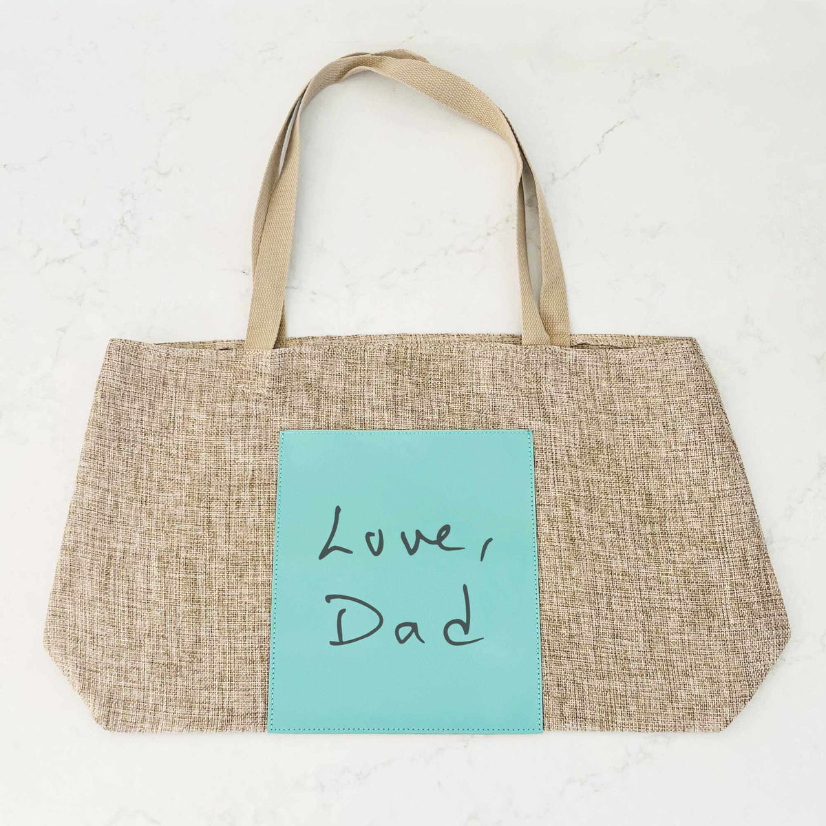 https://lovegeorgie.com/cdn/shop/files/handwriting-burlap-tote-bag-teal_1200x.jpg?v=1693338048