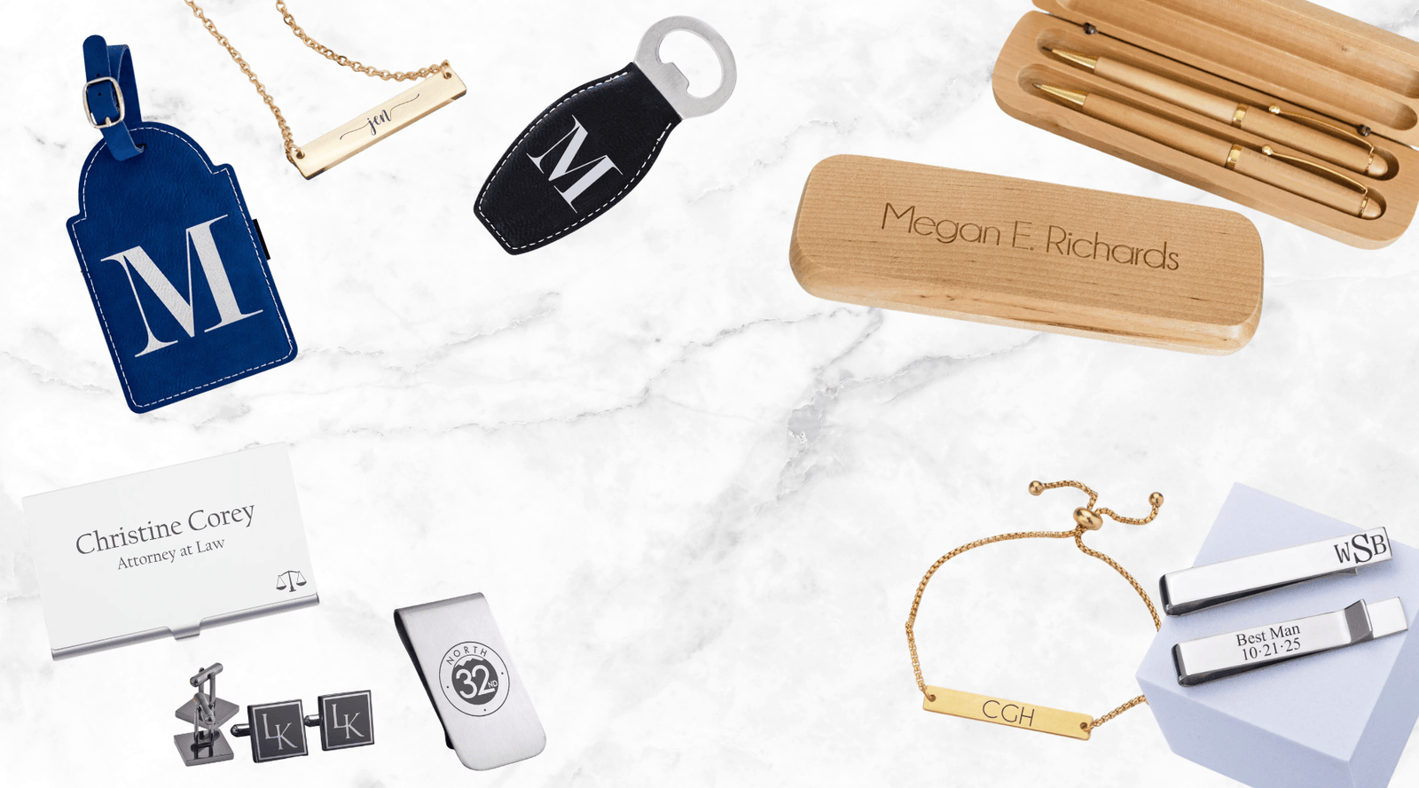 Collection of personalized, engraved jewelry and accessories on a marble surface
